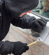 Thief Attempting to Open a Car